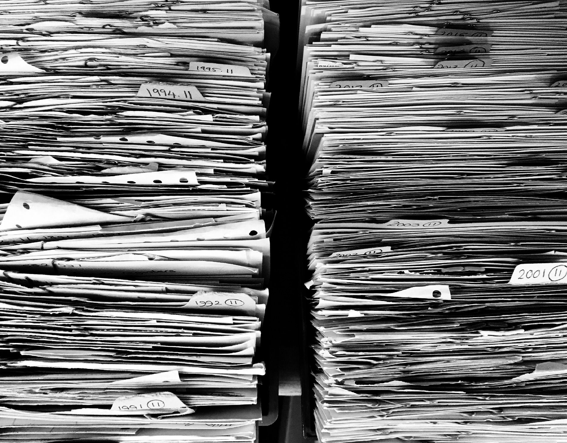 Piles of paper files and documents
